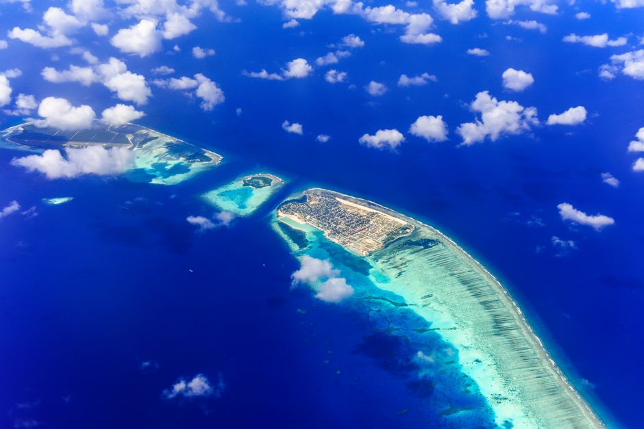 Stunning aerial view of tropical islands surrounded by azure waters, perfect for dream vacations.