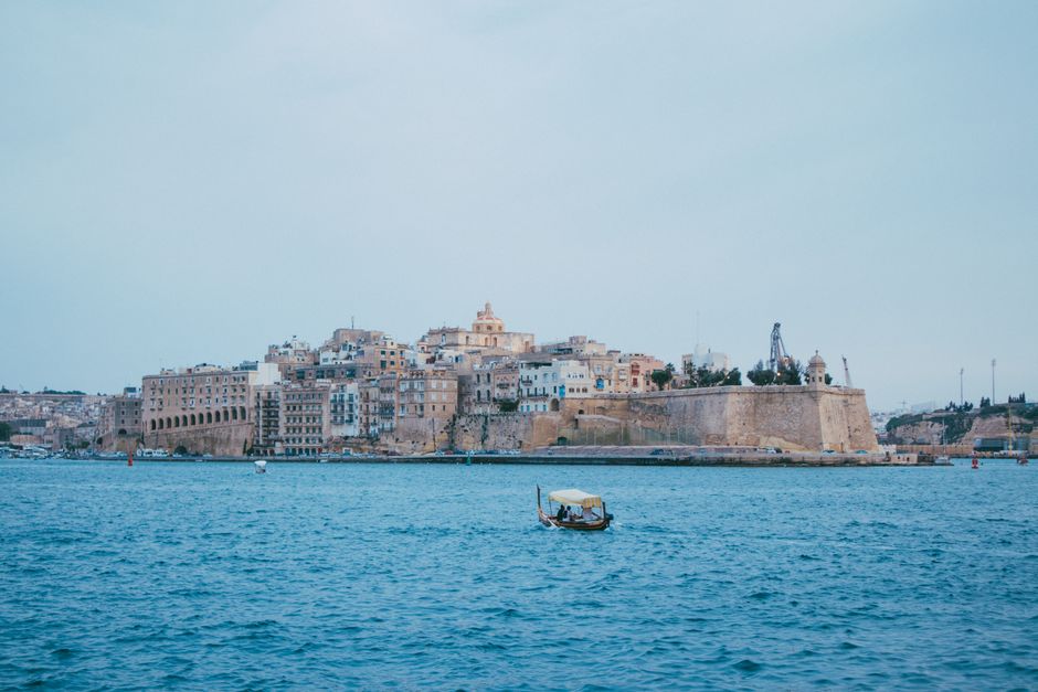 A beautiful view of Valletta's historic waterfront in Malta, featuring clear blue waters and iconic architecture.