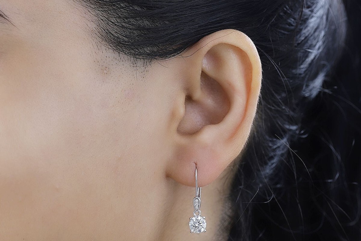 small lever back earrings worn for a dressed-up travel evening