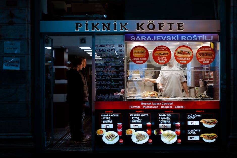 A vibrant night scene of a Turkish street food stall with customers ordering.