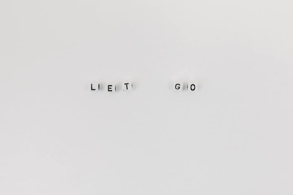 Minimalist composition featuring 'Let Go' spelled with letter dice on a clean white background.