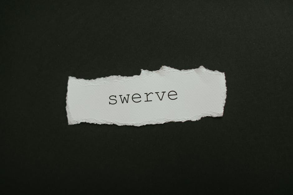 Close-up of torn paper with the word 'swerve' on a black background, ideal for concepts of change and direction.